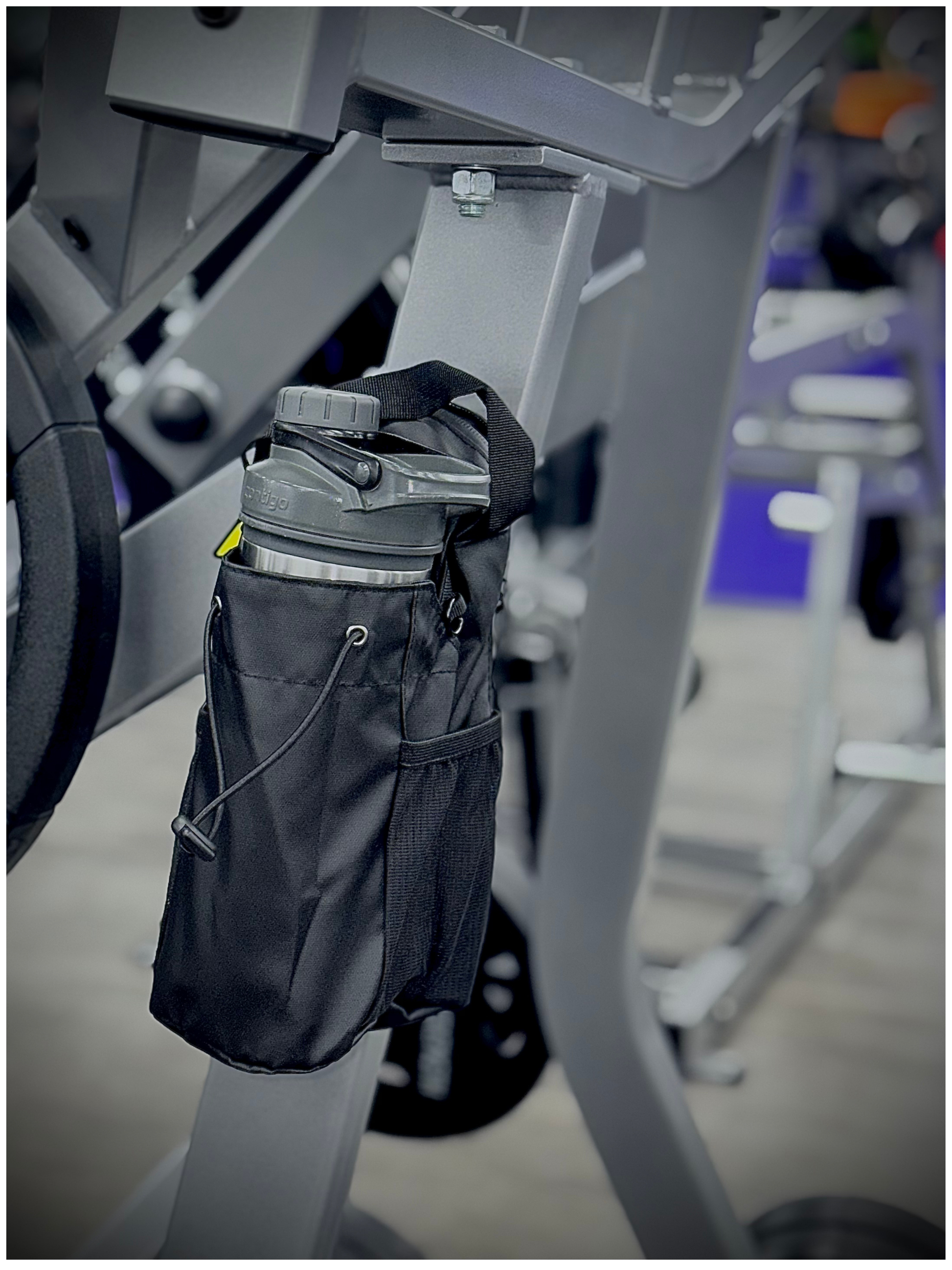 Magnetic gym bag attached to squat rack—keeps gear off gym floor